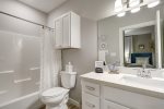 Guest en-suite bathroom 1 with a tub/shower combo